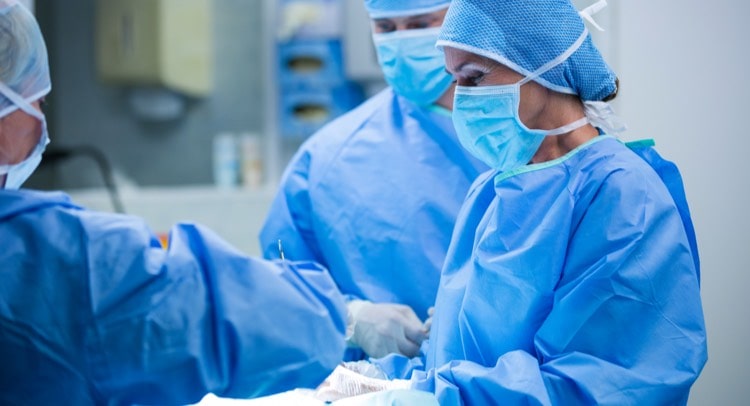 Close up of a surgeon performing an operation with other doctors