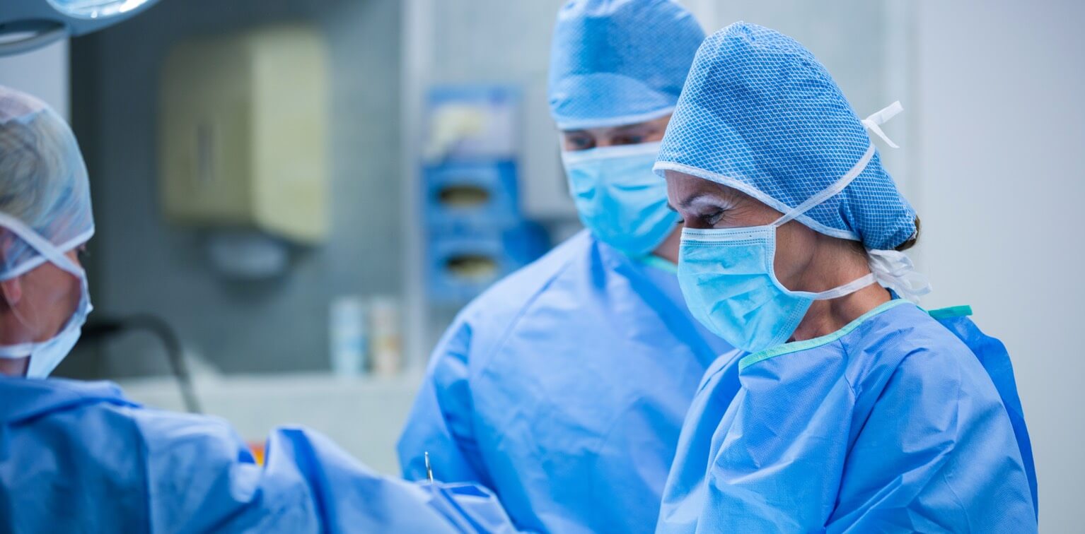 Close up of a surgeon performing an operation with other doctors